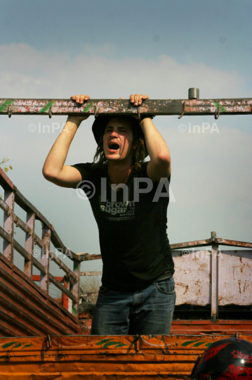 Foreign tourist travels on a truck in India