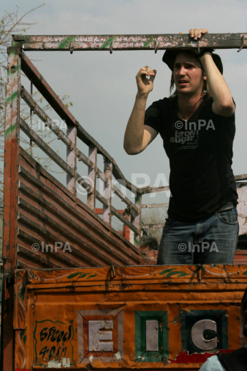 Foreign tourist travels on a truck in India