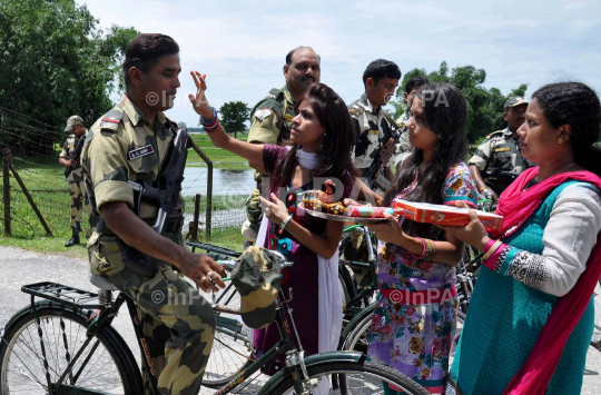 Indian girl tying Rakhi to BSF Jawans