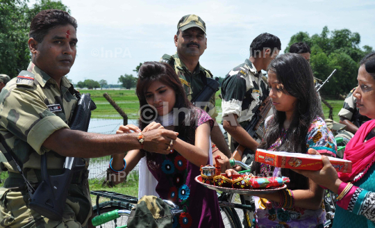 Indian girl tying Rakhi to BSF Jawans