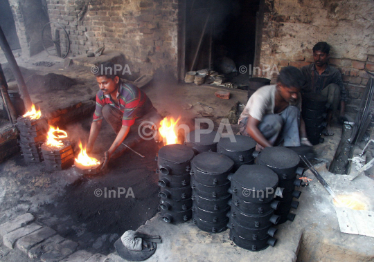 Labours melt metal to make plates