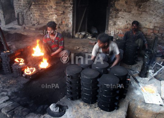 Labours melt metal to make plates