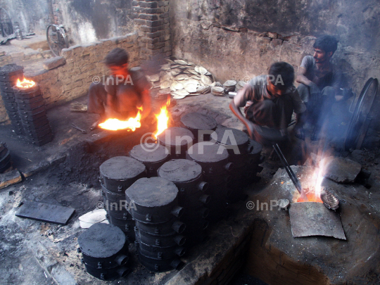 Labours melt metal to make plates